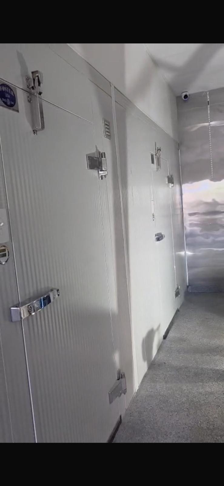 A bank of Foster USA walk-in cooler doors with cam-lock latches and the Foster USA nameplate, installed and in service